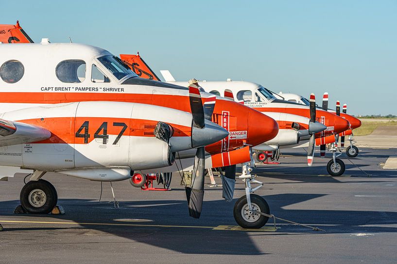 Three in a row: U.S. Navy Beechcraft T-44C Pegasus. by Jaap van den Berg