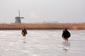 Ouderwets sleeen in de winter op het ijs in  Nederland van Eye on You