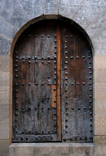 Old wooden door with metal rivets