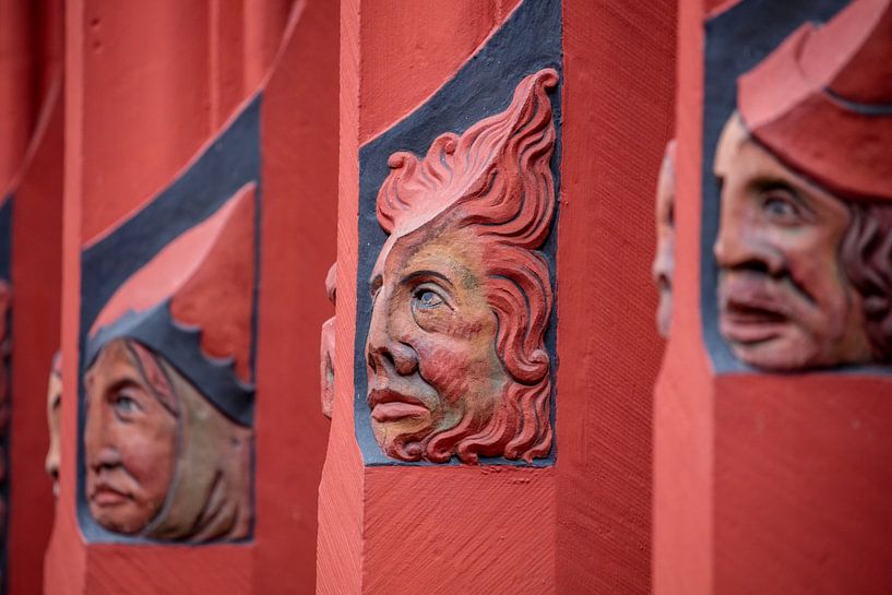 Heads on windows on the Basel Town Hall in Switzerland by Joost Adriaanse