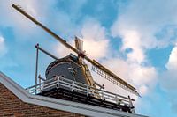 Dutch windmill against a partly clouded sky