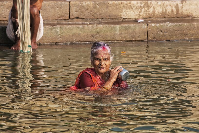 Hindu women's pilgrim takes a bath in the Sacred River Ganges by Tjeerd Kruse