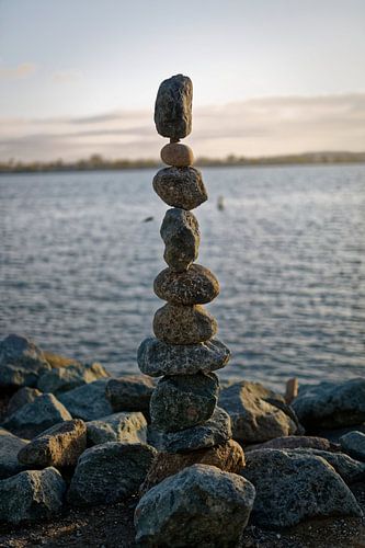 The art of Rock (stones) balancing with water, clouds and sky in the background