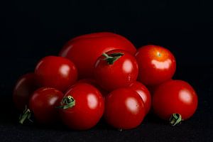 Tomatoes on black background