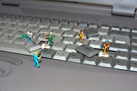miniature world men at work  laptop keyboard 