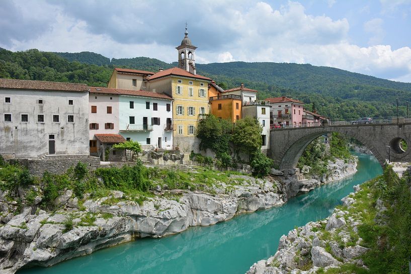 Bright blue river with colourful houses and bridge by My Footprints