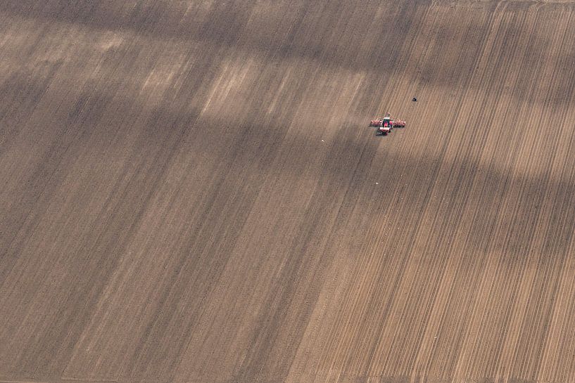 Aerial view of a tractor pulling an agricultural planter machine by Sjoerd van der Wal Photography