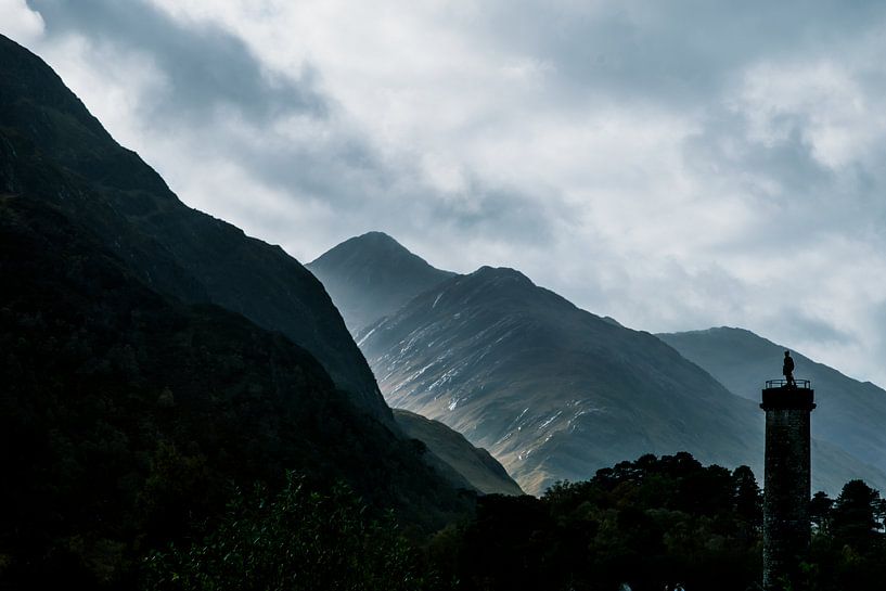 Silhouette of the Glenfinnan Monument with mountain range, Highlands, Scotland by Paul van Putten