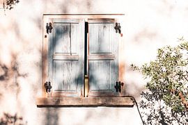 Shadow play on old wall with wooden shutters by Elma Maaskant