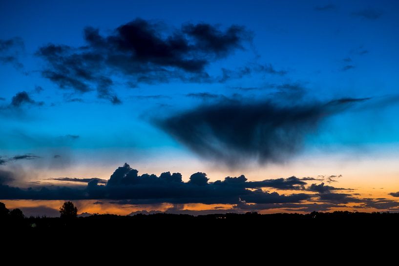 Early morning sun and silhouettes of clouds by Peter Bouwknegt