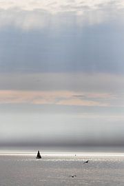 Sunbeams and sailing yacht at sea by Anne Zwagers