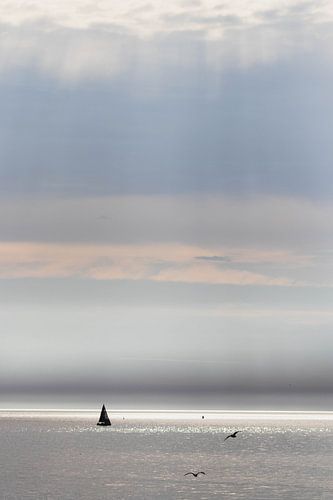 Sunbeams and sailing yacht at sea