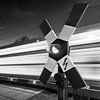 Level crossing with speeding train passing by by Frank Herrmann