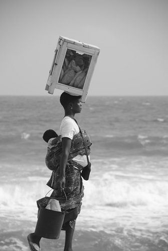 een afrikaanse bakkersvrouw in Togo op het strand 