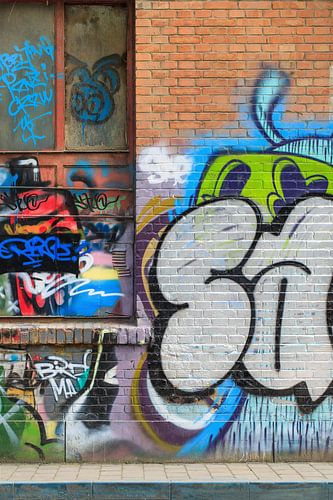 Brick wall with lively graffiti