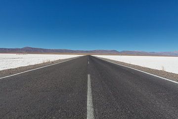 Asphalt road through the salt flats of Salinas Grandes, Argentina, South America