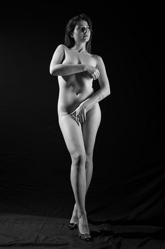 Beautiful nude woman in studio with black background
