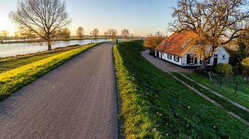 Farmhouse along the Meuse River in the late evening sun. by John Duurkoop