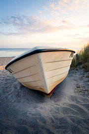 Maritime still life: A beached boat in the warm morning light by Nils Steiner