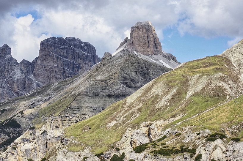 Majestic rock formations tower impressively into the sky: the Three Peaks present themselves in perfect light, surrounded by rugged peaks, alpine paths and barren high mountain landscape. by Miriam Schwarzfischer Fotografie