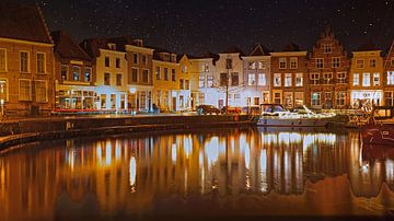 The harbour of Goes in nocturnal light with clear starry skies by Gert van Santen