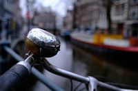 Bicycle bell against faded background canal