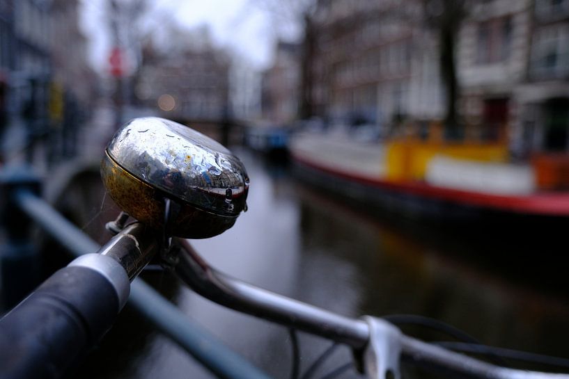 Bicycle bell against faded background canal by Rob Veneboer
