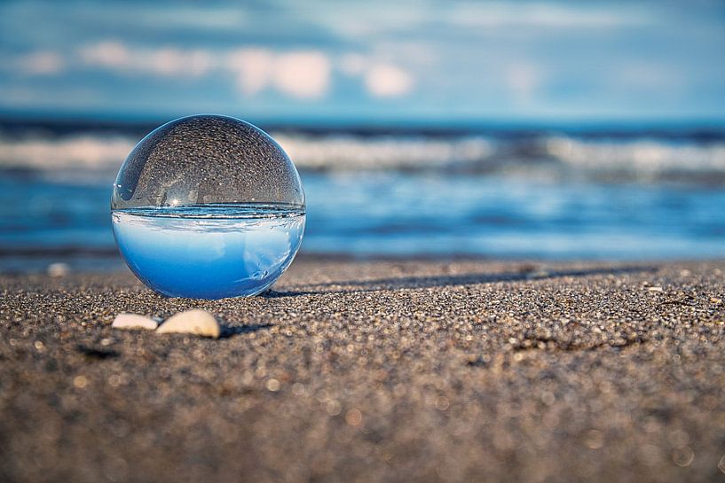 Glass ball on the beach of Zingst, with the Baltic Sea in the background by Martin Köbsch