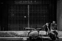 Old man in the streets of Bankok in the rain
