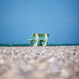 A bench on the beach in France, Normandy by Rob van der Teen