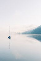 Lonely boat in a foggy lake in the mountains | Travel in the Dark Forest photo art print