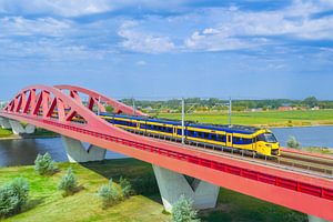 ICNG intercity train driving over the Hanzeboog railway bridge