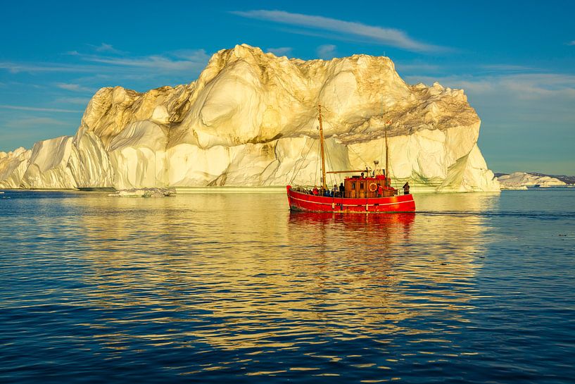 Iceberg with red fishing boat on Greenland by Chris Stenger