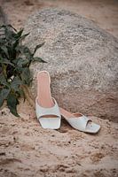Nahaufnahme von Hochzeitsschuhen im Sand