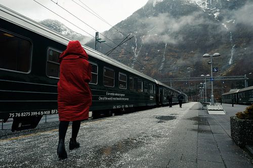 Woman in red coat at Flam station, Norway