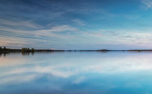 Blue sky and clouds reflected in the water