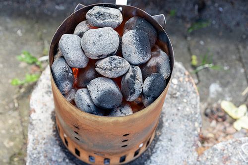 Glowing charcoal in the chimney starter
