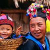 Laos. Luang Prabang. Mother with her son in a basket. by Frans Lemmens