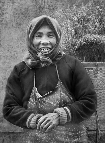 A Hmong woman with a basket of flowers