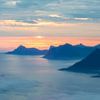 Midnight sun over mountains and tranquil sea by Karla Leeftink