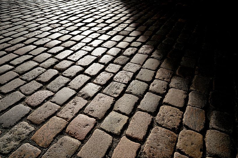 Cobblestones of a street in the old town by Heiko Kueverling