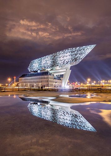 Port House Antwerp at night reflected in a pond