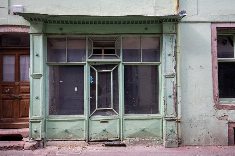 Old storefront in village in France by Joost Adriaanse