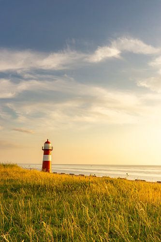 Sunset at the lighthouse of Westkapelle, Zeeland (vertical)