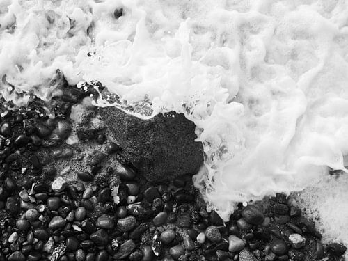 Felsen in der Brandung, fotografiert von oben schwarz-weiß