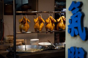 Chinese kitchen with chickens hanging from a rack by Mickéle Godderis