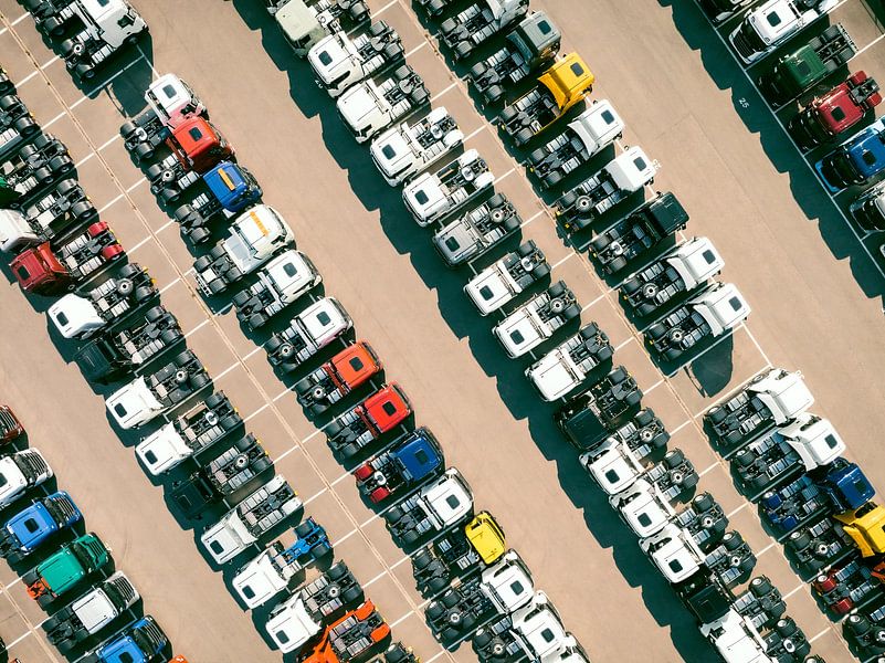 Trucks in a row at a parking lot seen from above by Sjoerd van der Wal Photography