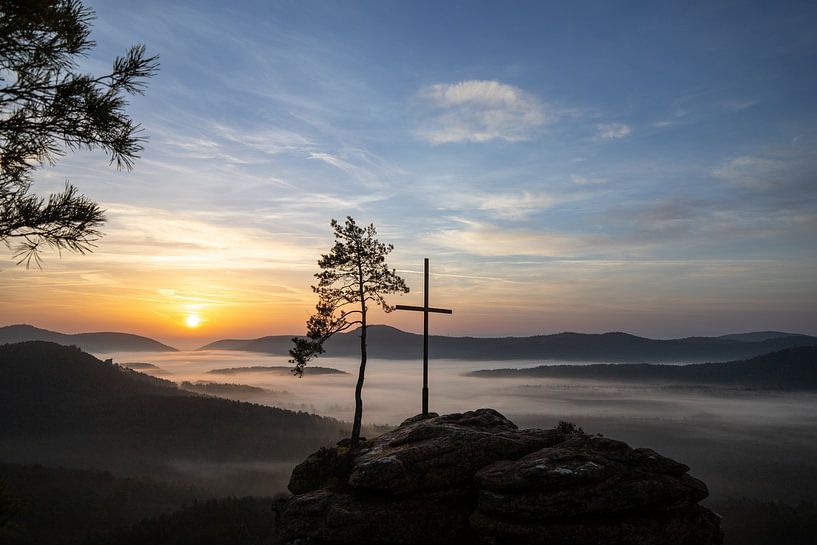 The Rötzenfels, a landscape shot of a sandstone rock with cross and tree, sunrise with fog in the va by Fotos by Jan Wehnert