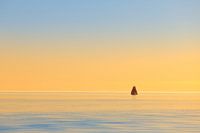 A sailing ship on the IJsselmeer during sunset