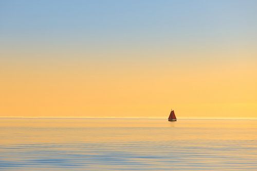 A sailing ship on the IJsselmeer during sunset